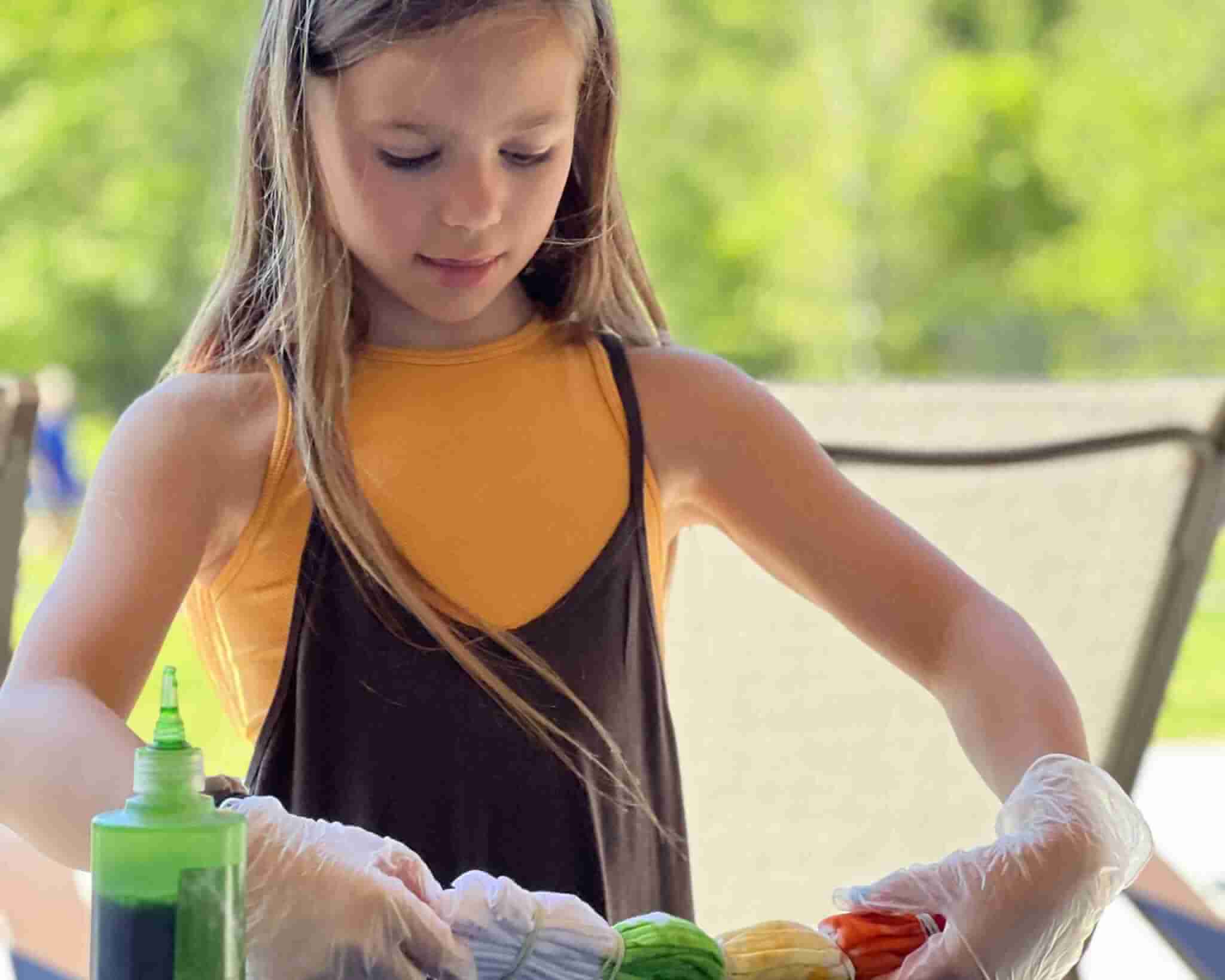 Young girl tie dying t shirts